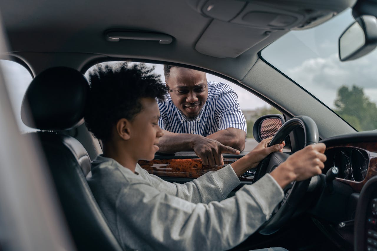 man in blue and white striped dress shirt sitting on car seat, boost productivity for Driving Instructor Owners and Managers.